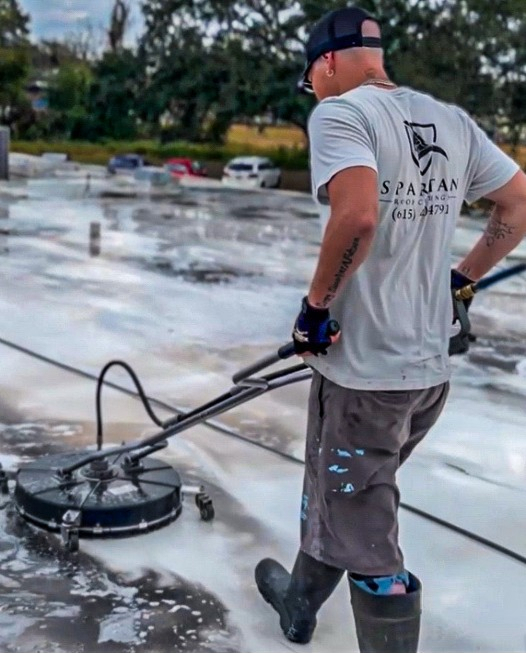Spartan Roof Coatings employee cleaning roof