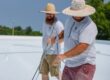 Two men together on a roof