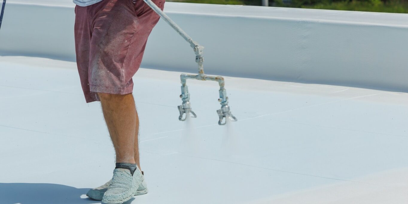 man spraying a roof Man spraying a roof with a coating